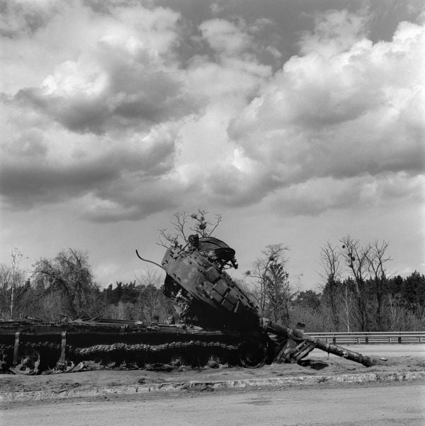 Book cover of Faces of War: Alexander Chekmenev, featuring a lone figure with a fire raging behind. Published by Kerber.