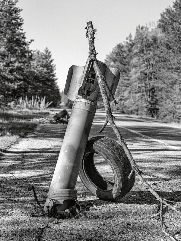Book cover of Faces of War: Alexander Chekmenev, featuring a lone figure with a fire raging behind. Published by Kerber.