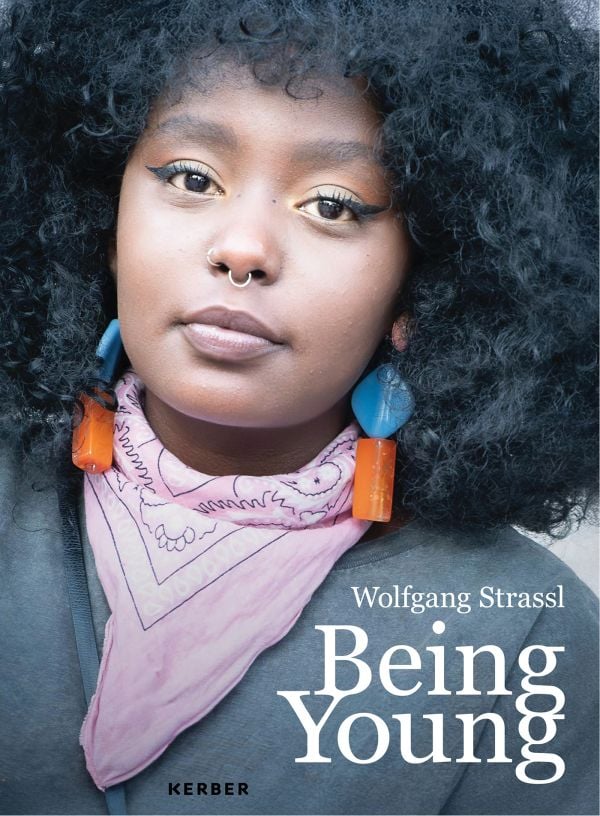 Book cover of Being Young: Portraits of Becoming; featuring a portrait of young woman with a septum piercing, wearing bold earrings and a pink scarf. Published by Kerber.