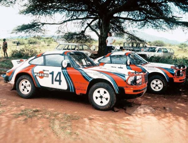 Porsche 930 near centre of bright yellow landscape cover of '111 More Porsche Stories That You Should Know', by Emons Verlag.