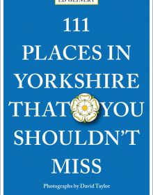 Yorkshire rose badge near center of blue cover of '111 Places in Yorkshire That You Shouldn't Miss', by Emons Verlag.