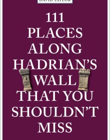 Two stone pillars near center of dark purple cover of '111 Places Along Hadrian's Wall That You Shouldn't Miss', by Emons Verlag.