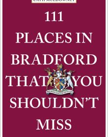 Council coat of arms near centre of wine red cover of '111 Places in Bradford That You Shouldn't Miss', by Emons Verlag.