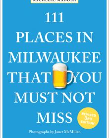 Glass tankard of beer near centre of blue cover of '111 Places in Milwaukee That You Must Not Miss', by Emons Verlag.