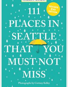 Falling raindrops, with yellow umbrella, on green cover of ' 111 Places in Seattle That You Must Not Miss', by Emons Verlag.