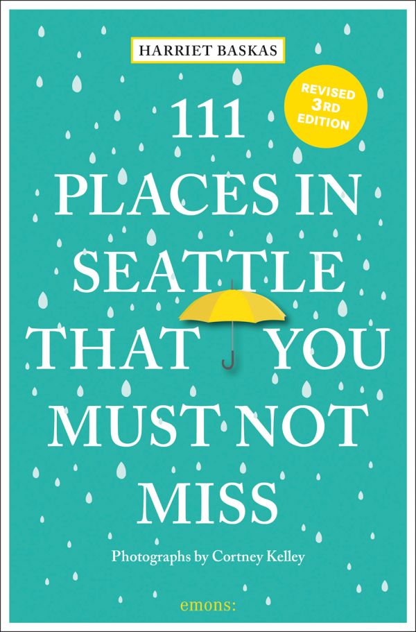 Book cover of Harriet Baskas' 111 Places in Seattle That You Must Not Miss, with a yellow umbrella surrounded by rain drops. Published by Emons Verlag.
