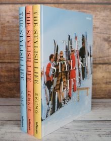 Book cover of The Stylish Life: Skiing, with a group of fashion models in vintage ski wear standing on snow. Published by teNeues Books.