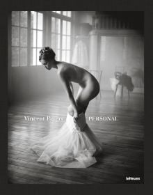 Nude white female model pulling on a white netted skirt, in studio space, Vincent Peters PERSONAL, in white font to lower left of centre cover.