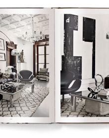 Interior space with wood dining table on rug, MOVE AND WORK, in white font above.