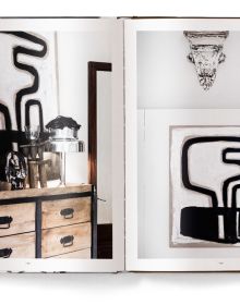 Interior space with wood dining table on rug, MOVE AND WORK, in white font above.