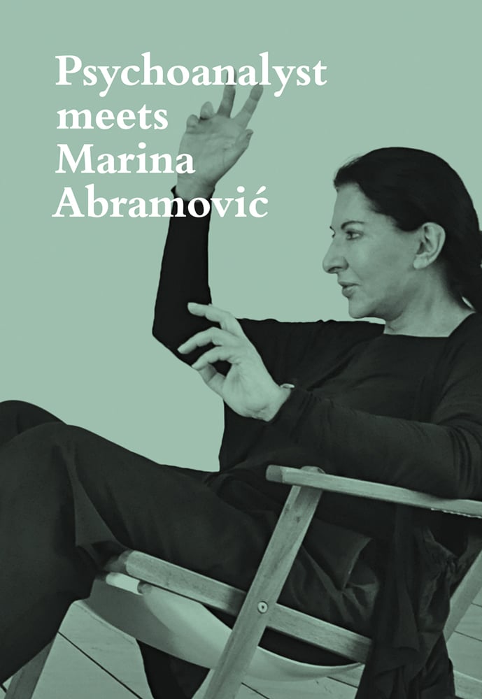 Marina Abramovic in black, seated, with hands in air on mint green cover, Psychoanalyst Meets Marina Abramovic in white font to upper left