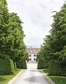 Low topiary hedges, large trees behind, on coral cover, The Gardens of La Gara in green font to lower left