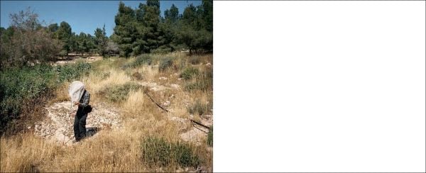 Book cover of Unresolved; with a camouflaged soldier leaning on building, with townspeople walk past brick building. Published by Scheidegger & Spiess.