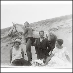 Bookshelf and table full of books and papers, The Giedion World Siegfried Giedion and Carola Giedion-Welcker in Dialogue in black font on bottom white banner