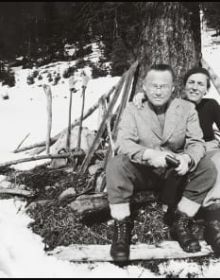 Bookshelf and table full of books and papers, The Giedion World Siegfried Giedion and Carola Giedion-Welcker in Dialogue in black font on bottom white banner