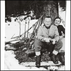 Bookshelf and table full of books and papers, The Giedion World Siegfried Giedion and Carola Giedion-Welcker in Dialogue in black font on bottom white banner