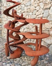 Tall curved wood sculptures in exhibition space, Anthony Cragg Endless Form in white font to upper left