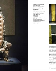 Hunchbacked nude male covering genitals, yellow cover with 3 black holes, Michael Kvium A Retrospective in black font to lower right