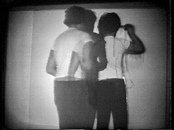 Photo montage of black and white shots of topless model, with black spray paint covering images below, Travaux/Works 1964-2013 in white font to bottom right.