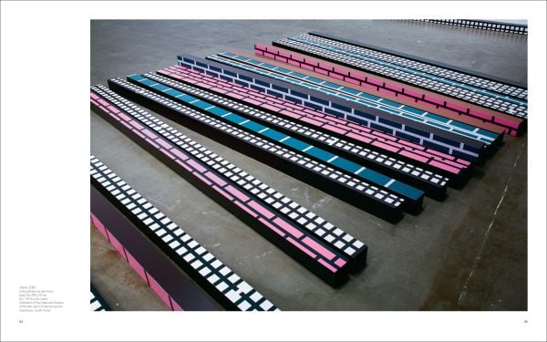 Geometric print of yellow flower shapes and blue lines joined to make squares, off white cover, HONG SEUNG-HYE ORGANIC GEOMETRY in blue font.