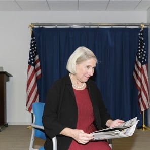 Newspaper front page with article headings, New Cut in black at top and American Readers at Home vertically on right in black font on white cover.