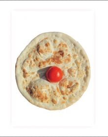 White book cover of Pizza is god, with a circular pizza with small, red tomato to center. Published by Verlag Kettler.