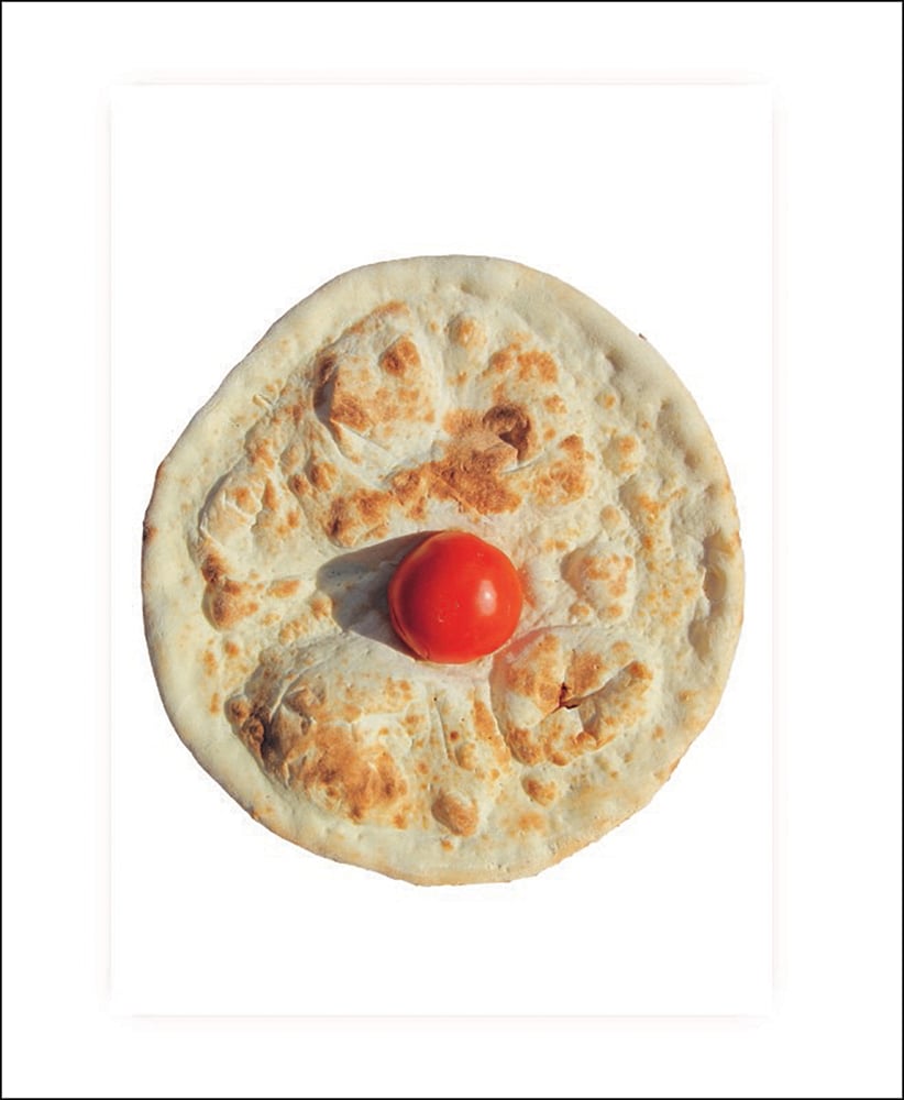 White book cover of Pizza is god, with a circular pizza with small, red tomato to centre. Published by Verlag Kettler.