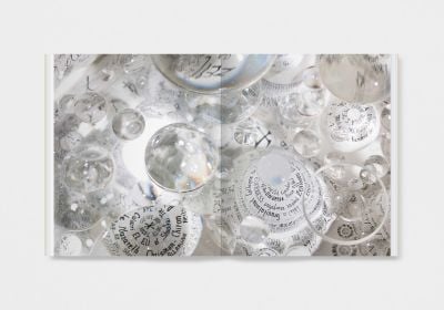 Book cover of Mary Bauermeister, Signs, Words, Universes, with convex glass with bubbles and notes in pen. Published by Verlag Kettler.