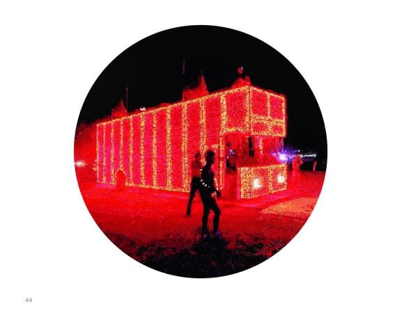 Landscape book cover of Romer + Romer, Burning Man/Electric Sky, with art installation shooting out fire into night sky, with crowds of people circling. Published by Verlag Kettler.