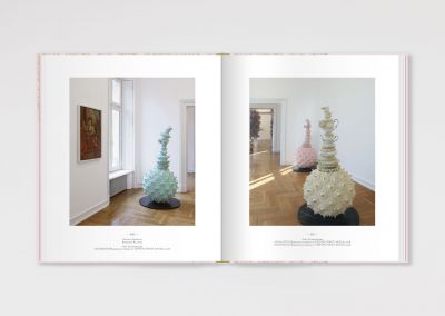 Pink book cover of Der Flexible Plan, Das Rokoko in der Gegenwartskunst, with a threaded orange drape to top. Published by Verlag Kettler.