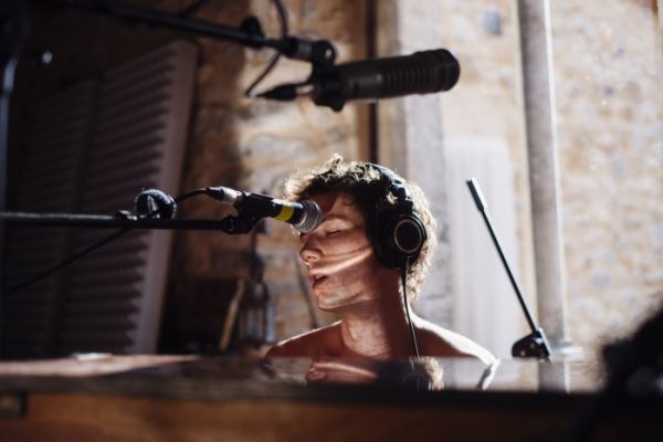 Cream book cover of My Friends Got Famous, with red and white striped flip flop floating on top of in blue swimming pool water. Published by Verlag Kettler.