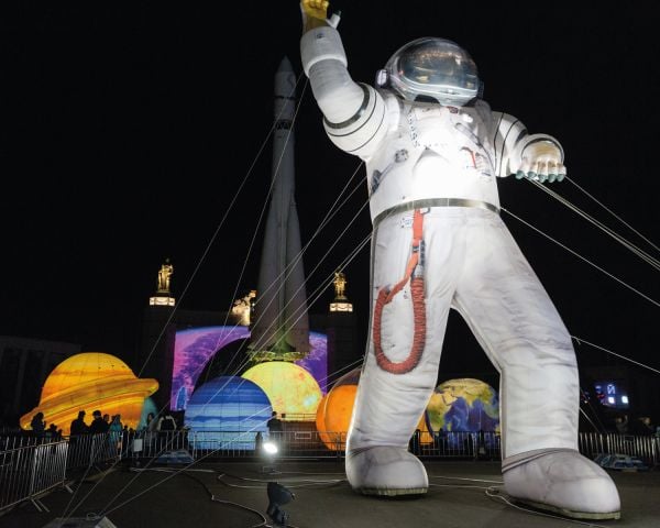 Landscape book cover of Cosmic Culture, Soviet Space Aesthetics in Everyday Life, featuring a Cosmonaut in helmet and suit, with drapes behind. Published by Verlag Kettler.