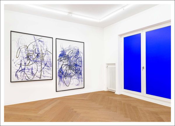 White book cover of Jana Schröder, The Early Years, featuring the female artist staring sternly at the camera as she stand on step of campervan. Published by Verlag Kettler.