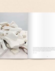 Black book cover of Talya Lubinsky, Marble Dust, with a fragment of white marble mottled with grey. Published by Verlag Kettler.