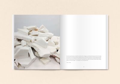 Black book cover of Talya Lubinsky, Marble Dust, with a fragment of white marble mottled with grey. Published by Verlag Kettler.