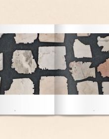 Black book cover of Talya Lubinsky, Marble Dust, with a fragment of white marble mottled with grey. Published by Verlag Kettler.
