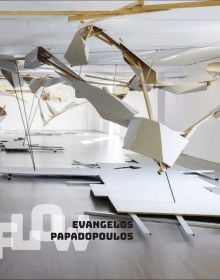 Installation on large plasterboard and wood bird like structures hanging from ceiling, EVANGELOS PAPADOPOULOS in black font, overlapping FLOW in white, to bottom left.