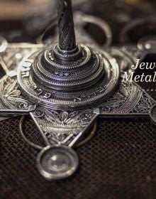 Book cover of Artisans of Israel: Transcending Tradition; featuring an artist weaving. Published by Arnoldsche Art Publishers.