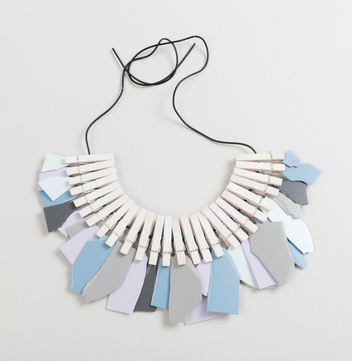 Pale blue oblong jewellery shapes with arrangement of small spiky stars on white cover, Jewelry of Ideas in pale grey