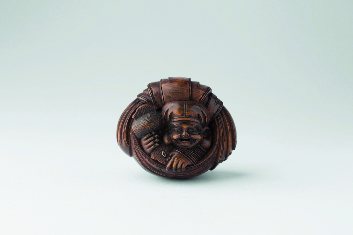 Netsuke of bear in robe, grey cover, Netsuke in Comparison in red font above, red left border