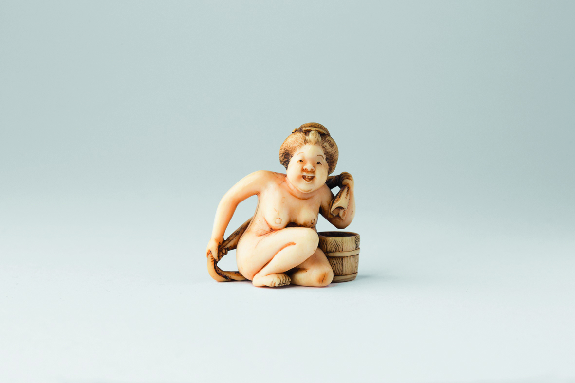 Book cover of Netsuke in Comparison: Motifs and Their Variations, featuring a netsuke of monkey wearing a robe. Published by Arnoldsche Art Publishers.