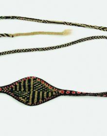 Book cover of Encountering - Retracing - Mapping: The Ethnographic Legacy of Heinrich Harrer and Peter Aufschnaiter, with an antique Tibetan steel-flint kit with leather handle, and green stone. Published by Arnoldsche Art Publishers.
