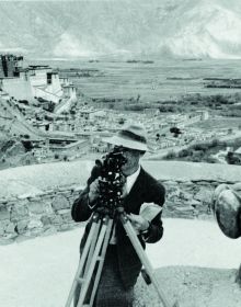 Book cover of Encountering - Retracing - Mapping: The Ethnographic Legacy of Heinrich Harrer and Peter Aufschnaiter, with an antique Tibetan steel-flint kit with leather handle, and green stone. Published by Arnoldsche Art Publishers.
