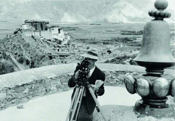 Book cover of Encountering - Retracing - Mapping: The Ethnographic Legacy of Heinrich Harrer and Peter Aufschnaiter, with an antique Tibetan steel-flint kit with leather handle, and green stone. Published by Arnoldsche Art Publishers.