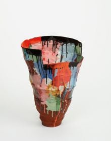 Glazed red ceramic wheel shape, on white cover, Vessel Sculpture 3 in dark red font to top