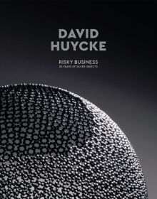 Book cover of David Huycke: Risky Business. 25 Years of Silver Objects, with a decorative sphere-shaped metal sculpture. Published by Arnoldsche Art Publishers.