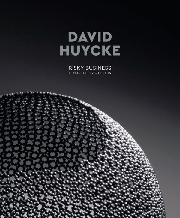 Book cover of David Huycke: Risky Business. 25 Years of Silver Objects, with a decorative sphere-shaped metal sculpture. Published by Arnoldsche Art Publishers.