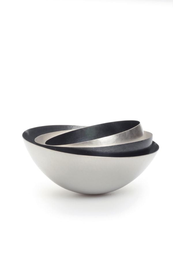 Book cover of David Huycke: Risky Business. 25 Years of Silver Objects, with a decorative sphere-shaped metal sculpture. Published by Arnoldsche Art Publishers.