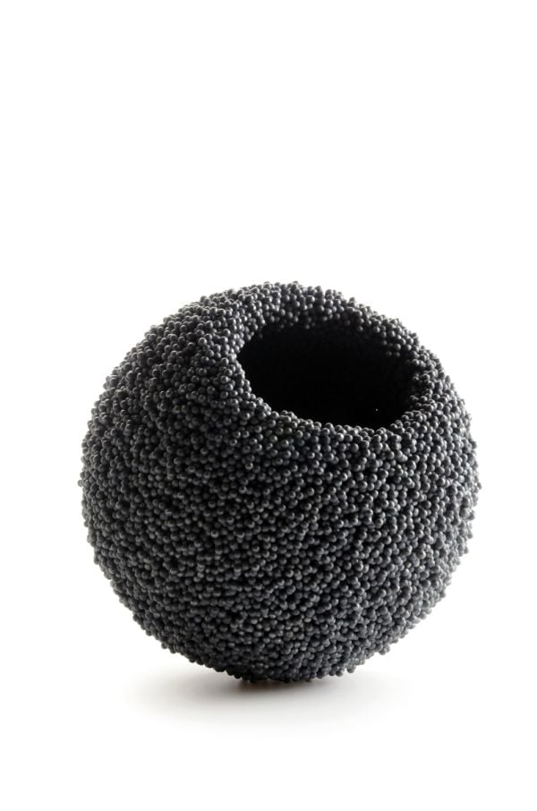 Book cover of David Huycke: Risky Business. 25 Years of Silver Objects, with a decorative sphere-shaped metal sculpture. Published by Arnoldsche Art Publishers.