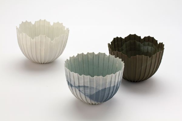 Delicate cream filigree porcelain bowl, on white cover, Barbel Thoelke Porzellan in white and black font below